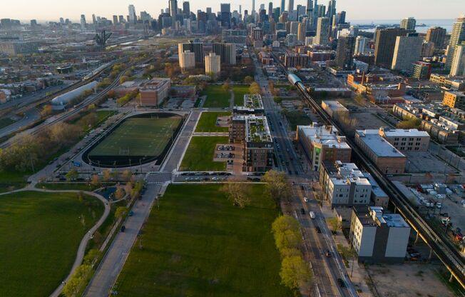 A cityscape with a mix of residential and commercial buildings, a river, and a park.
