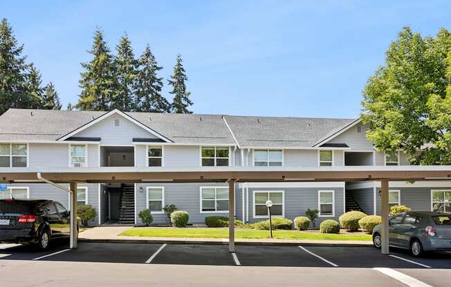 A building with a grey roof and a white garage door.