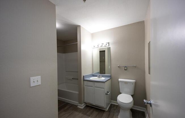 a bathroom with a toilet and a sink and a shower at Magnolia Pointe Apartments in Duluth, GA