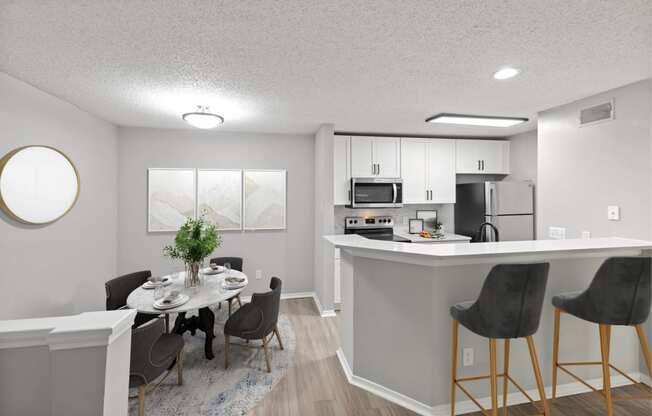 an open kitchen and dining room with a table and chairs