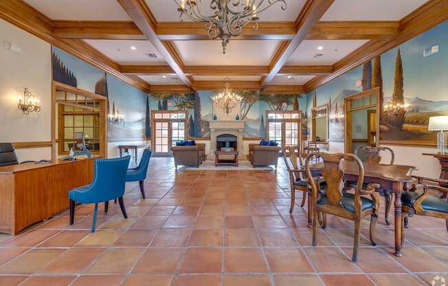 A large room with a fireplace and a chandelier.
