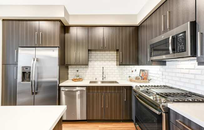 a kitchen with stainless steel appliances and wooden cabinets