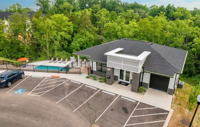 a house with a swimming pool and a parking lot