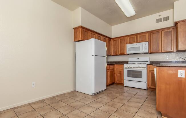 a kitchen with a stove and a refrigerator