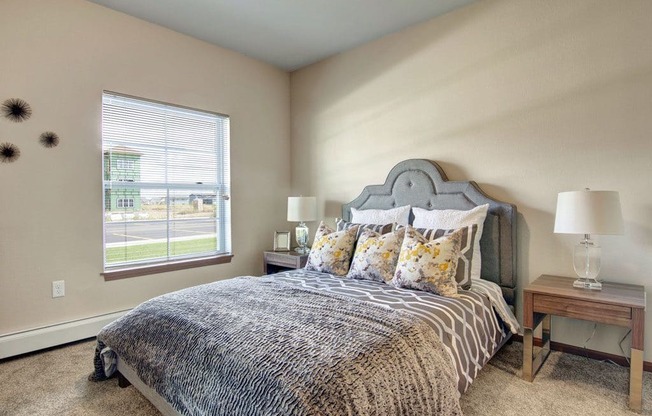 a bedroom with beige walls and a large window