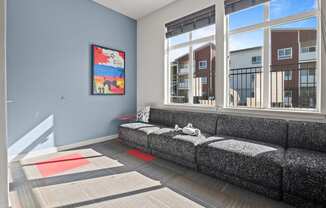 a living room with a couch and large windows