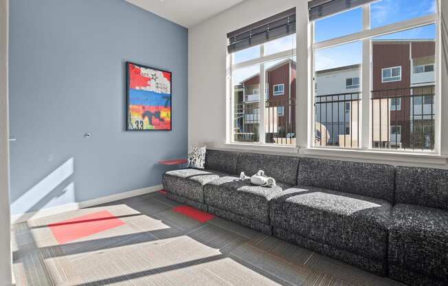 a living room with a couch and large windows