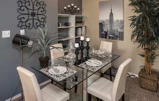 a dining room with a glass table and white chairs