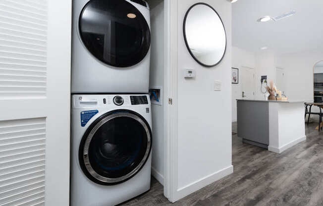 A modern laundry room with a washing machine and a dryer.