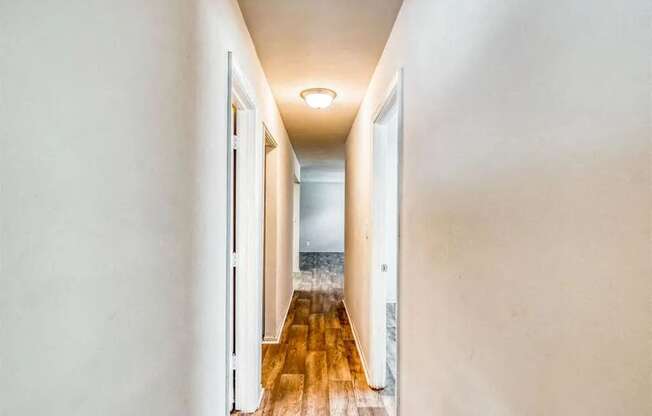 a long hallway with doors and a lamp on the ceiling at Gates of West Bay, Norfolk, VA