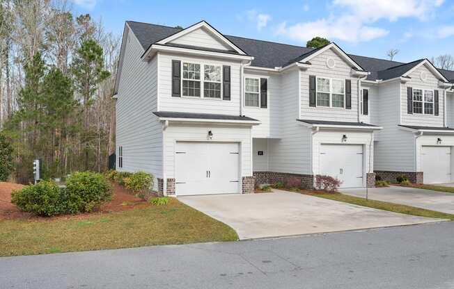 Harris Trail Luxury Townhomes for rent Richmond Hill, GA photo of white townhome with garage