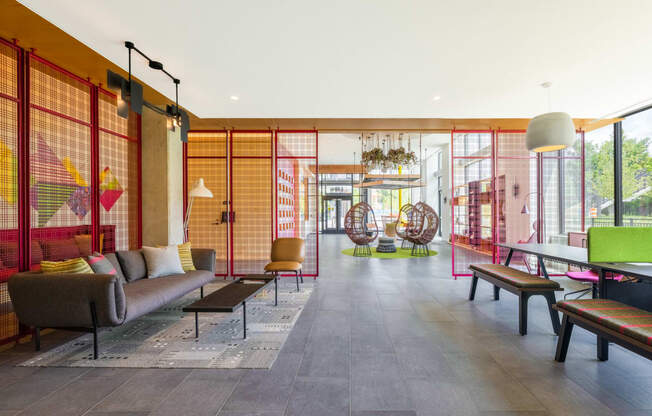 a living room with a couch and chairs and a ping pong table