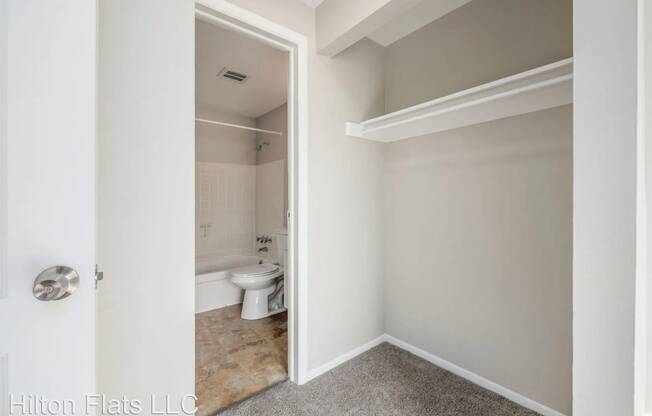 a small bathroom with a toilet and a closet