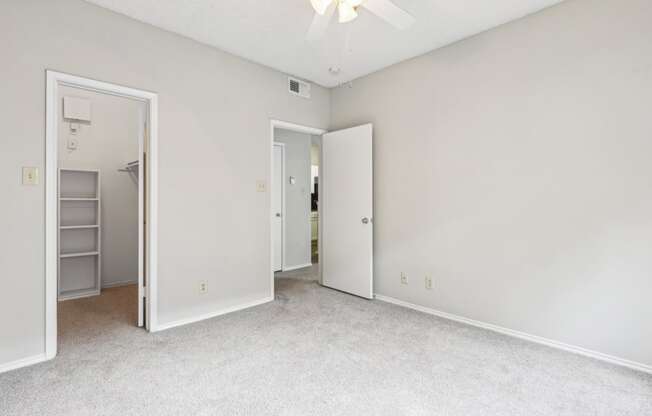 A1 floor plan bedroom with a ceiling fan at Jefferson Creek Apartments in Irving, TX.