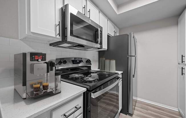 A modern kitchen with a black stove top oven and a black refrigerator.