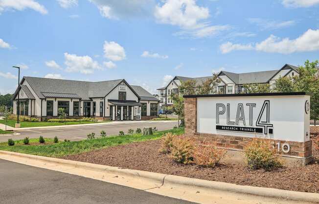 a pata sign in front of a parking lot with houses in the background