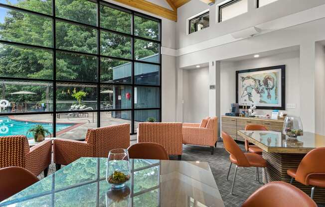 A modern dining room with a glass table and chairs.