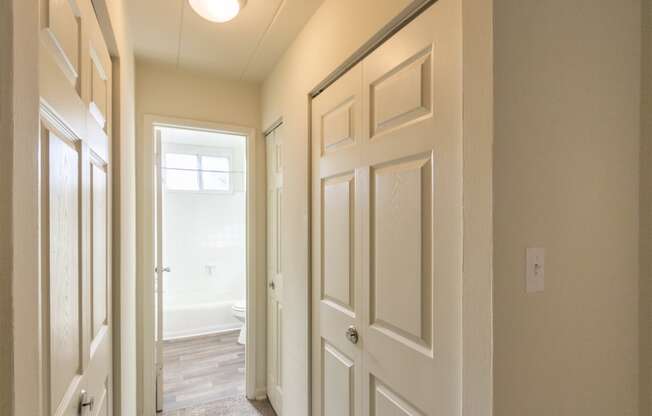 This is a photo of the hallway leading to the bathroom in the 550 square foot 1 bedroom, 1 bath patio apartment at College Woods Apartments in the North College Hill neighborhood of Cincinnati, OH.
