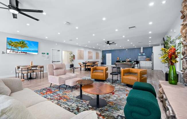 A living room with a large flat screen TV mounted on the wall.