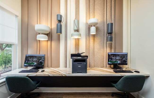 a desk with two computers and three monitors on it