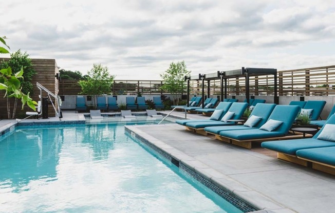 Resort-inspired pool with cabanas and lounge sun deck seating