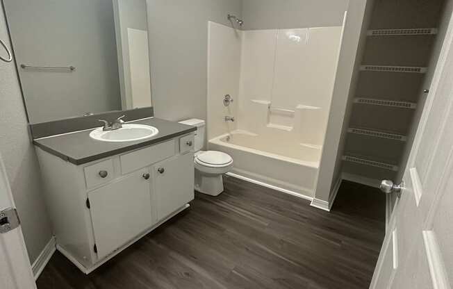 an empty bathroom with a sink toilet and bathtub