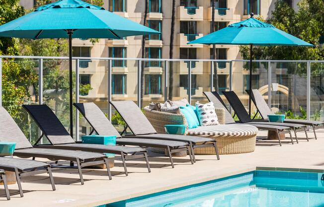 Poolside seating with shaded daybeds for unwinding in the sun.
