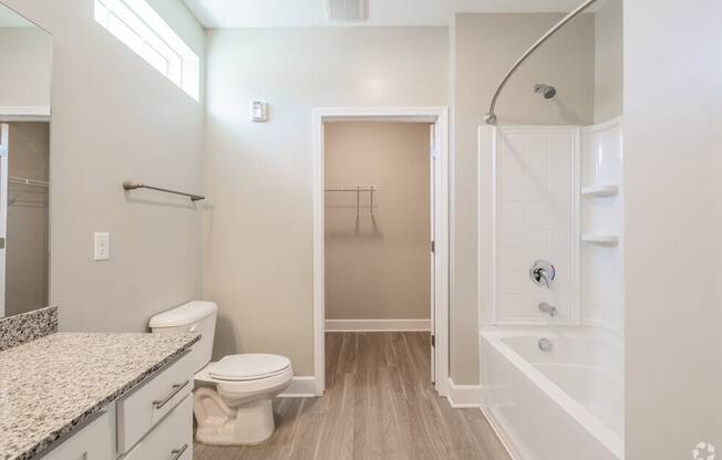 a bathroom with a shower and a toilet and a sink