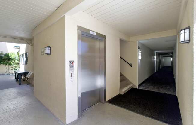 a metal elevator in a hallway of a building  at Willow Tree Apartments, Torrance, CA, 90505
