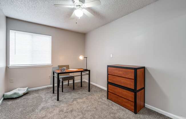 an office with a desk and a chair and a window