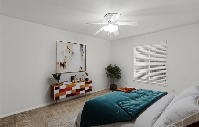 a bedroom with a bed and a ceiling fanat Millcreek Woods Apartments, Olathe, 66061