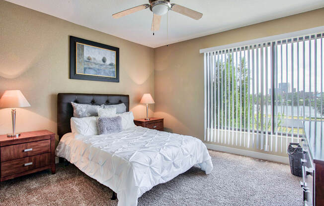 a bedroom with a large window and a ceiling  At Metropolitan Apartments in Little Rock, ARfan