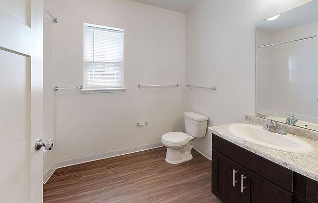 Large bathroom with a window and hard surface flooring