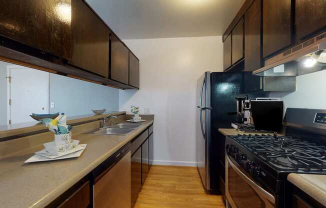 a kitchen with a stove and a sink and a refrigerator