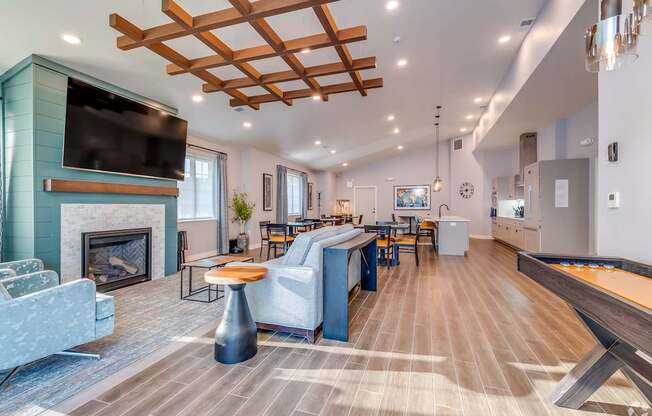 A modern living room with a fireplace and a TV mounted above it.