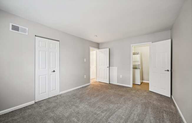 an empty room with white doors and a carpeted floor at ReNew Odenton