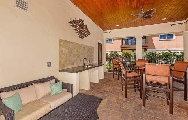 a living room with a couch a table and a ceiling fan  at Hacienda Club, Jacksonville, FL