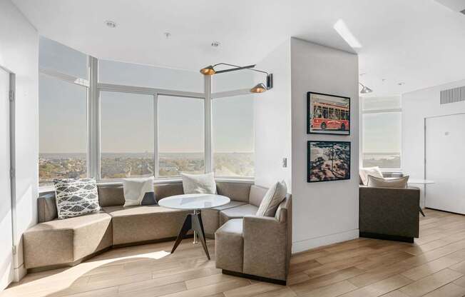 A living room with a large window overlooking a cityscape.