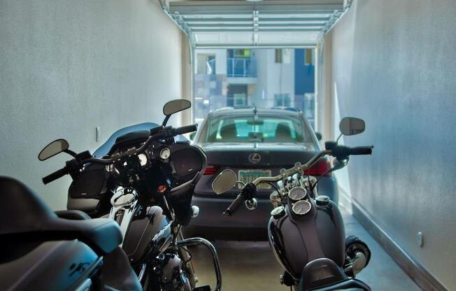The Craft at Gilbert and Baseline apartment garage showing two motorcycles in the foreground and