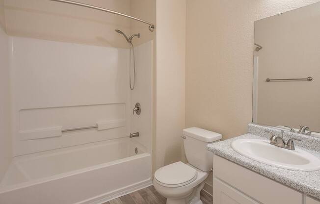 A white bathroom with a toilet, sink, and bathtub at Sunset Summit, Rocklin, CA, 95765