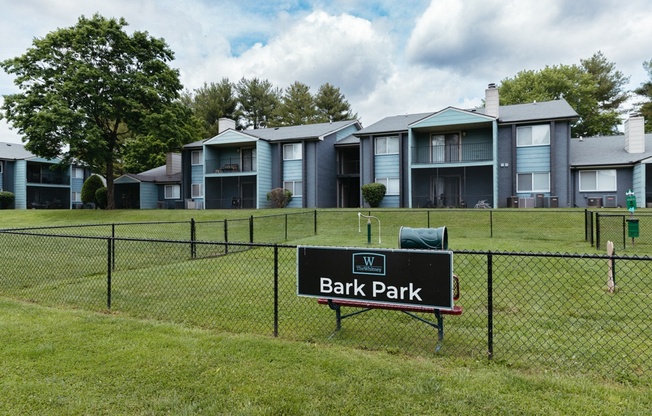 the park at bark park with apartment buildings in the background