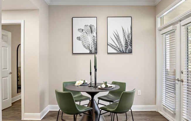 a dining room with a table and chairs and two pictures on the wall at The Verandah, Austin, Texas