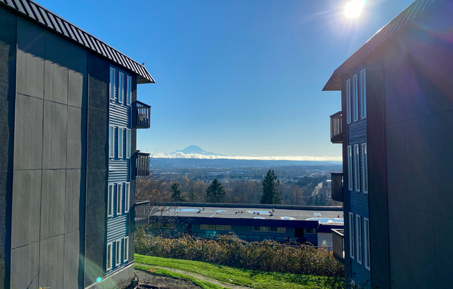 Apartments for Rent in Renton WA - Sunset View - This is the exterior of the apartment building with natural landscaping and views of Mt. Rainier.
