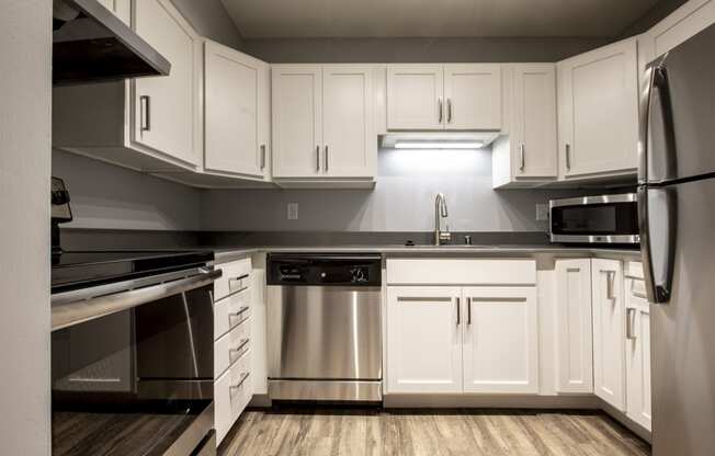 updated kitchen with stainless steel appliances and counter tops