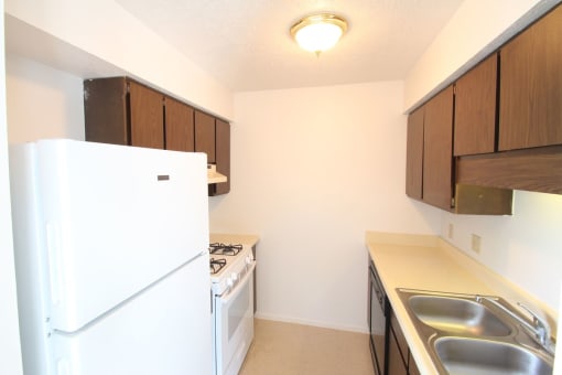 a kitchen with a stove refrigerator and a sink