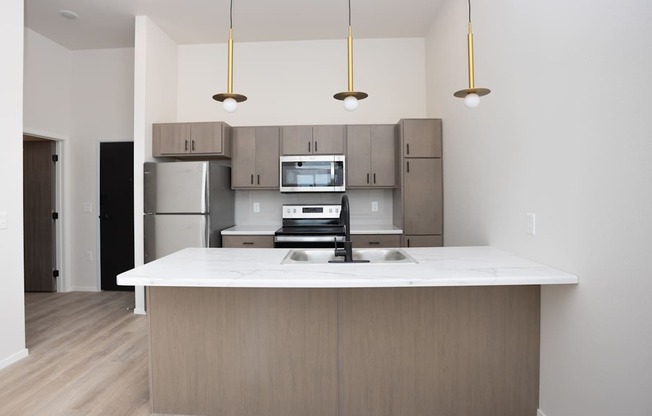 A kitchen with a white counter top and wooden cabinets.