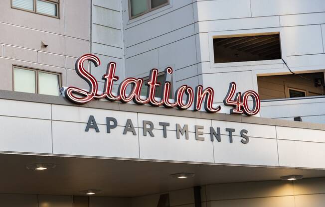 a sign for station 40 apartments on the side of a building