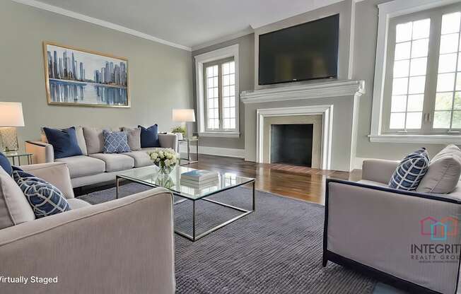 A living room with a fireplace and a television.