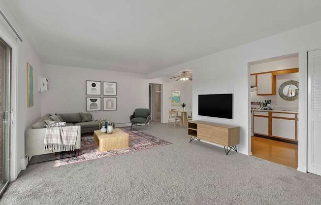 a living room with grey carpet and white walls