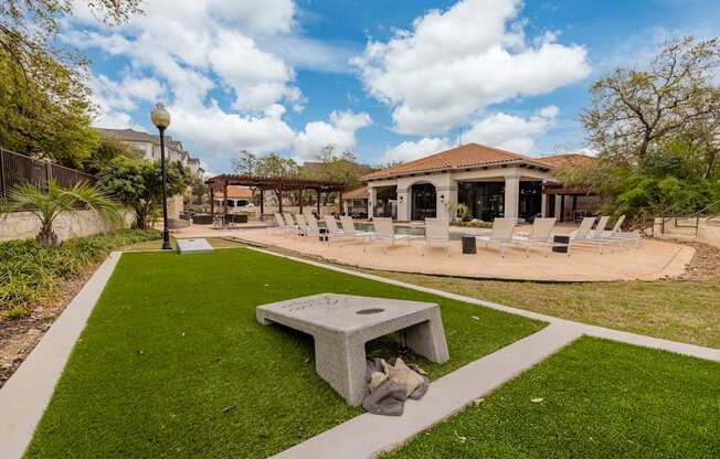 a patio with chairs and a fire pit